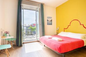 a bedroom with a bed and a large window at Ostello Bello Milano Centrale in Milan