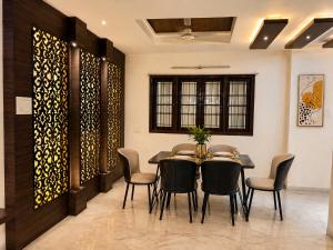 a dining room with a table and chairs at Urbana Luxury AC Duplex Bungalow with Pergola Terrace in Nagpur