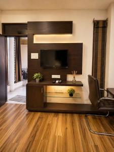 a living room with a flat screen tv on a wall at Urbana Luxury AC Duplex Bungalow with Pergola Terrace in Nagpur