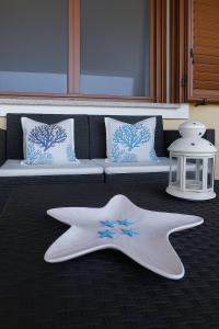 a large white starfish laying on the floor next to a couch at Villa Beafe' Ogliastra con piscina in Tertenìa +35 photos