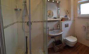 a bathroom with a shower and a sink and a toilet at Ferienwohnung Graf Knurrhahn in Karlshagen