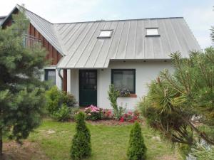 a white house with a gray roof at Ferienwohnung Graf Knurrhahn in Karlshagen +29 photos