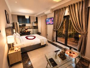 a bedroom with a large bed and a large window at Bryanston Palms Accommodation in Johannesburg