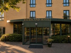 a building with a revolving door in front of it at Haukeland Hotell in Bergen
