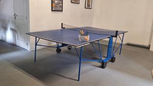 a ping pong table with a net on it at Appartement Privé, Camping La Pointe in Châteaulin