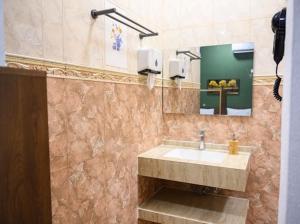 a bathroom with a sink and a mirror at Saal house in Nizwa