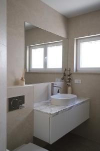 a bathroom with a sink and a mirror at Apartment Maestral, Pucisca ,Island Brac in Pučišća +28 photos