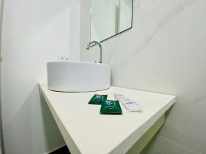 a bathroom counter with a sink and a lamp on it at Pousada Nosso Lar - Opte sem ou com Café, Estacionamento e a uma Quadra da Praia in Guarujá