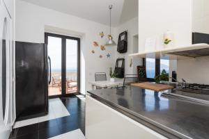 a kitchen with a view of the ocean at Villa Margi in Vico Equense