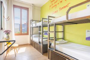 a room with bunk beds in a hostel at Ostello Bello Milano Centrale in Milan