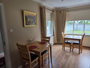 a dining room with a table and chairs and a window at Lilac Manor in Sligo