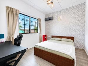 a bedroom with a bed and a desk and a window at Sunset Seaview Bay Villa in Putatan