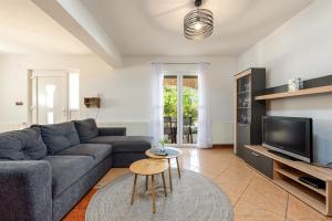 a living room with a couch and a tv at Villa Balen ZadarVillas in Lisičići