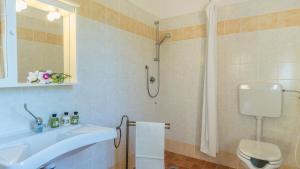 a bathroom with a sink and a shower at PODERINA DEI POGGI 12, Emma Villas in Castiglione del Lago