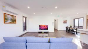 a living room with a blue couch and a table at Evergreen 3B Home by Goodlive in Clyde