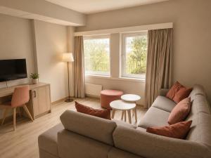 a living room with a couch and a tv at Haukeland Hotell in Bergen +17 photos