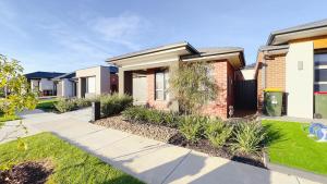 a brick house with a sidewalk in front of it at Evergreen 3B Home by Goodlive in Clyde