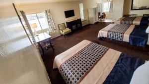 a hotel room with two beds and a television at Magnuson Hotel Sierra Vista in Sierra Vista