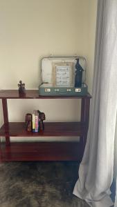 a shelf with a suitcase sitting on top of it at Indaba tree lodge in Bulawayo