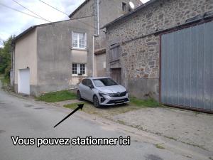 a small car parked in front of a building at Le studio du Sabotier in Oradour-Saint-Genest