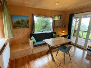 a living room with a couch and a table at Chalet panoramique et moderne tout confort in Saizy