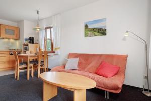 a living room with a couch and a table at Haus Baden in Hagnau