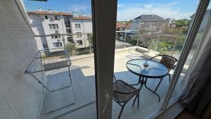 a view of a balcony with a table and chairs at Семеен хотел Сирена in Ahtopol