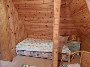 a bedroom with a bed in a wooden wall at Reethus Mandy in Staphel