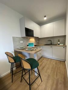 a kitchen with a table with chairs and a laptop on it at Apartmán KOZAK LITMAN in Litmanová