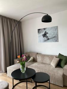 a living room with a couch and a table at Apartmán KOZAK LITMAN in Litmanová +9 photos