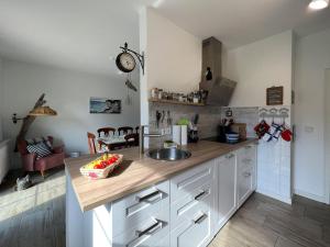 a kitchen with a sink and a counter top at Familienhaus Sonne in Mukran