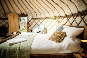 a bedroom with a bed in a yurt at Kelburn Yurts - Cockle in Fairlie +10 photos