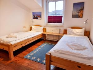 a room with two beds and a window at Ferienwohnung Lorenz in Sassnitz