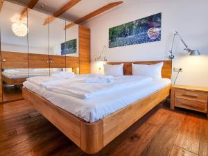 a bedroom with a large bed with white sheets at Ferienwohnung Lorenz in Sassnitz