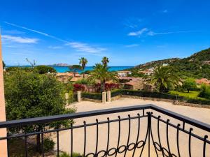 a balcony with a view of the ocean at Piazzetta Dei Pini Two Bedroom Apartment 100 m from the Beach in Baja Sardinia