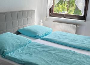 two beds with blue pillows sitting next to each other at Ferienwohnung Stockrose in Lohme