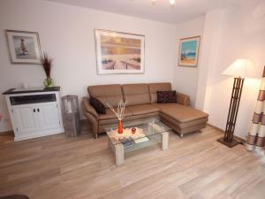 a living room with a couch and a table at Villa Amelie App Seestern in Sassnitz