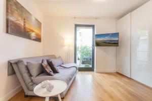 a living room with a couch and a table at Villa Friede-Marie App Freya in Sassnitz