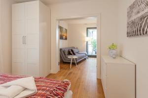 a living room with a couch and a chair at Villa Friede-Marie App Freya in Sassnitz