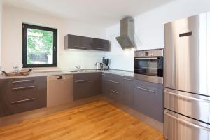 a kitchen with stainless steel appliances and a window at Villa Friede-Marie App Freya in Sassnitz +8 photos