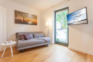 a living room with a couch and a window at Villa Friede-Marie App Freya in Sassnitz