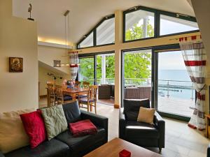 a living room with a couch and a table at Villa Friede-Marie, Penthouse Lenea in Sassnitz