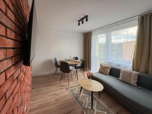 a living room with a couch and a table at Apartament Bałandy 32 in Oświęcim