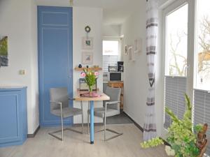 a kitchen and dining room with a table and chairs at Villa Monika App 7 in Sassnitz