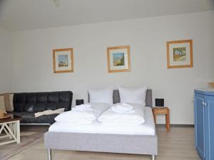 a bed in a living room with a couch at Villa Monika App 7 in Sassnitz