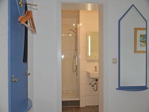a bathroom with a shower and a mirror at Villa Monika App 7 in Sassnitz +2 photos