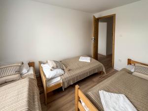 a room with two beds and a door to a bedroom at Apartament Bałandy 32 in Oświęcim