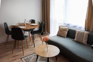 a living room with a couch and a table at Apartament Bałandy 32 in Oświęcim