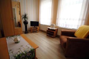 a living room with a couch and a table at Ferienwohnung Thurk in Sassnitz