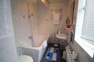 a bathroom with a tub and a toilet and a sink at Ferienwohnung Thurk in Sassnitz